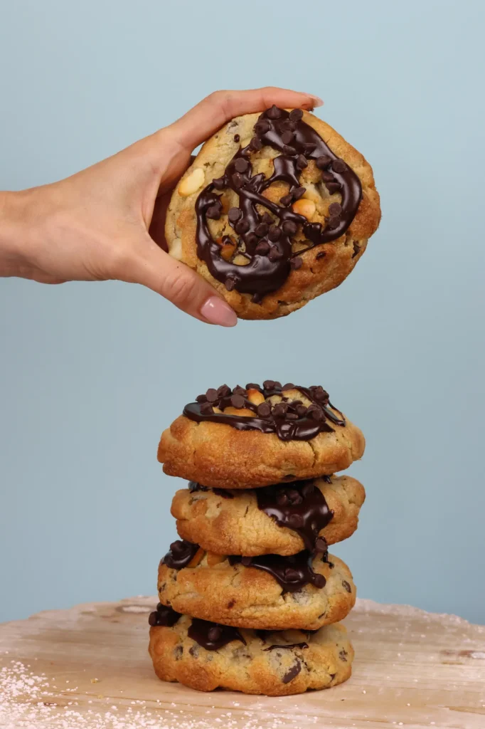 Stack of Ganache chocolate cookies topped with melted chocolate and chocolate chips