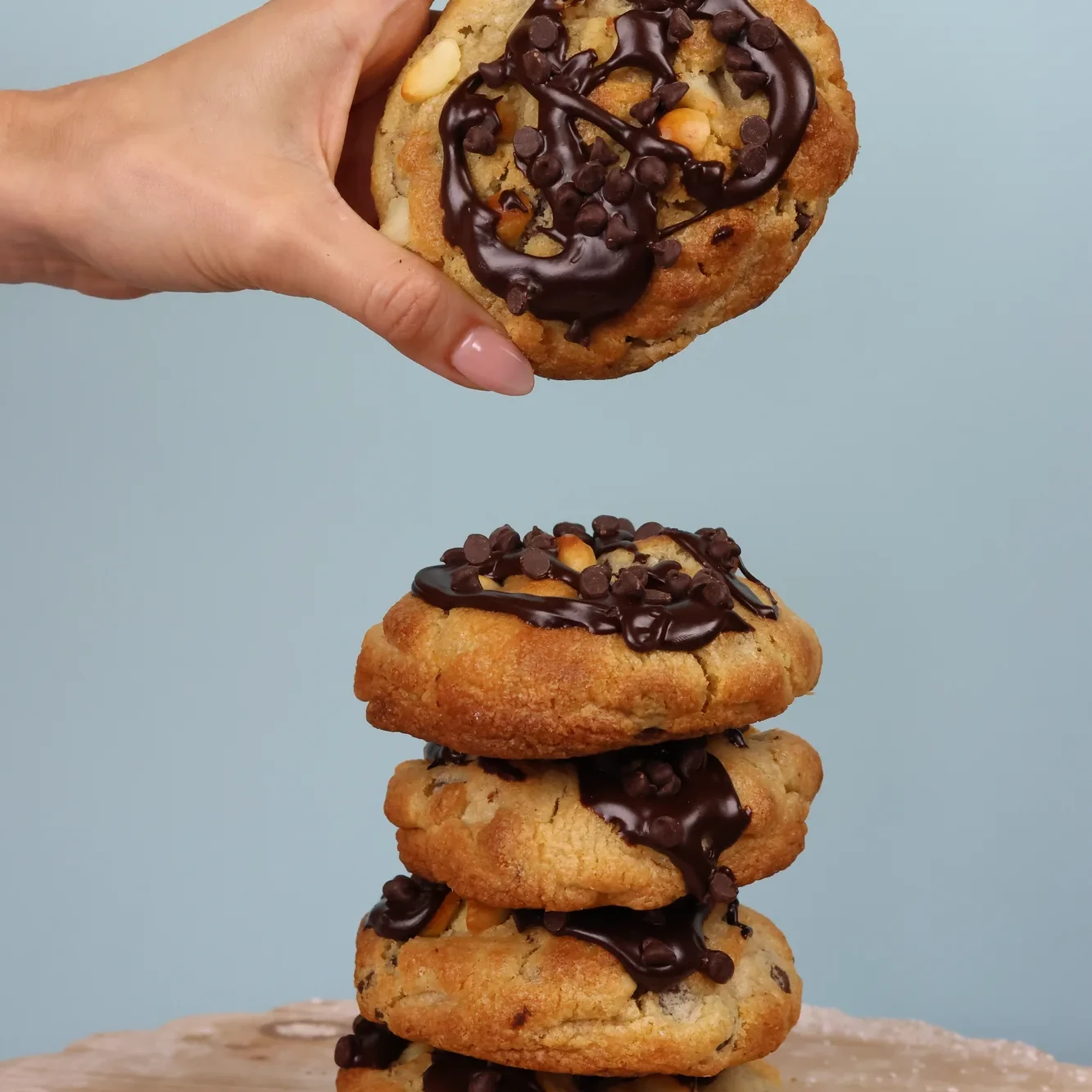 Stack of Ganache chocolate cookies topped with melted chocolate and chocolate chips